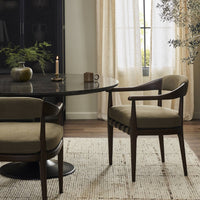 Nolan Dining Chair in Broadway Olive, featuring curved arms and comfortable upholstery.