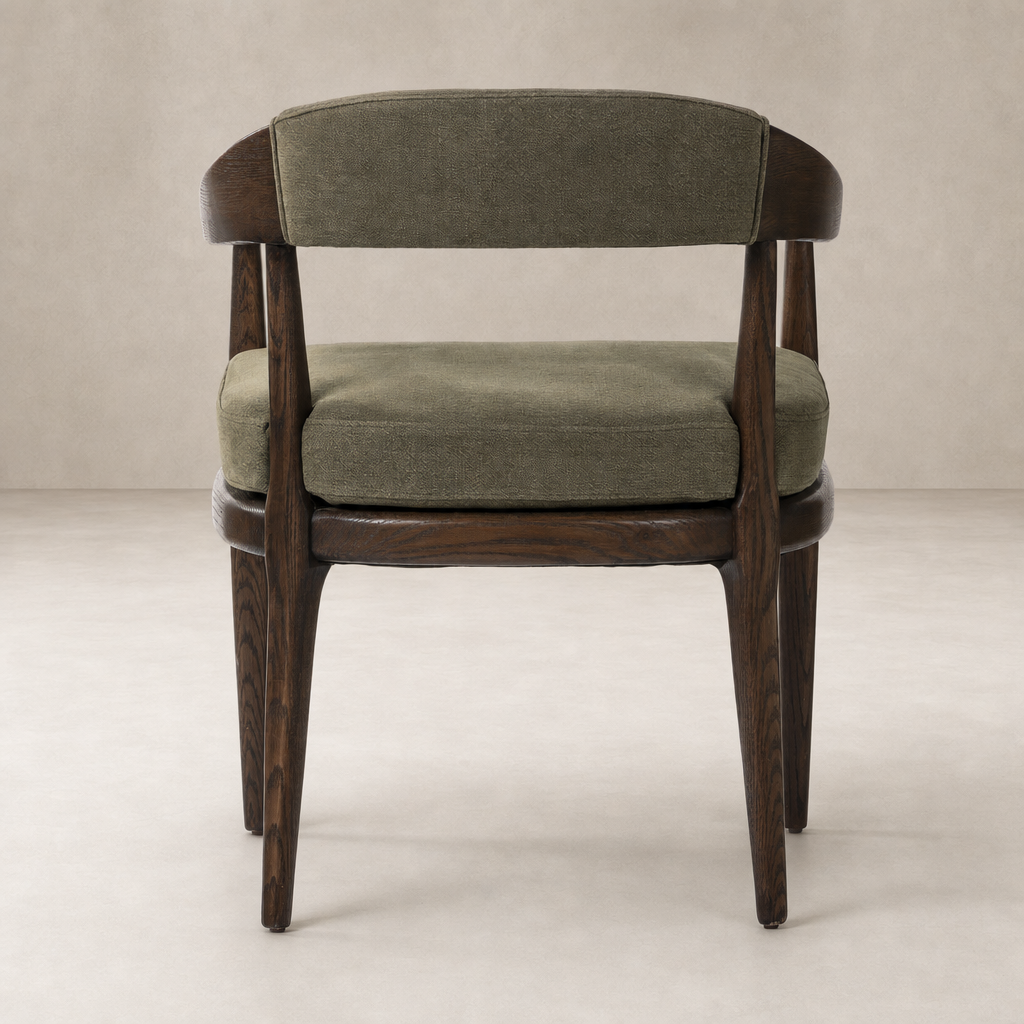Nolan Dining Chair in Broadway Olive with a curved back and sturdy wooden legs.