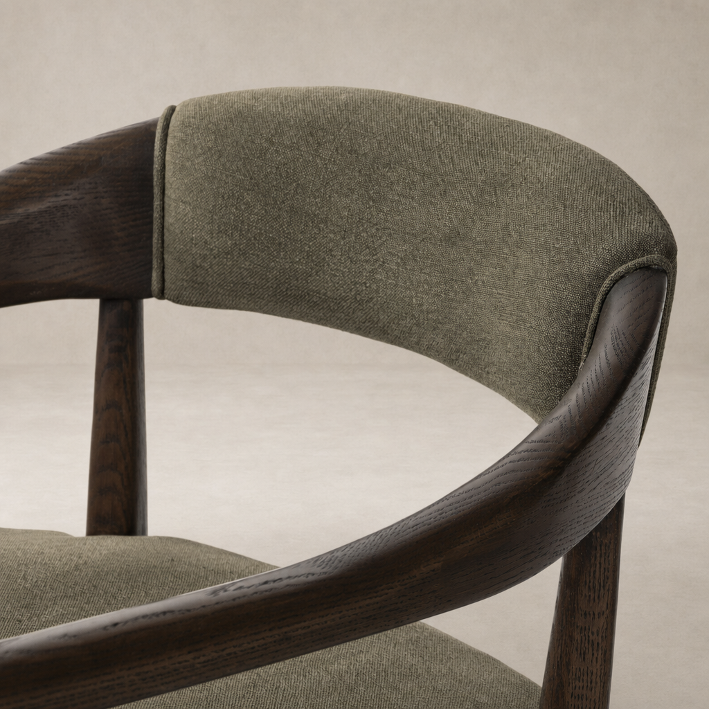 Close-up of the Nolan Dining Chair in Broadway Olive, showcasing its textured fabric and wood finish.
