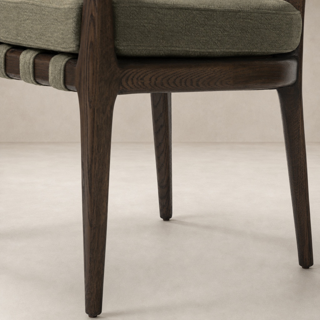 Nolan Dining Chair with Broadway Olive upholstery and sleek wooden legs.