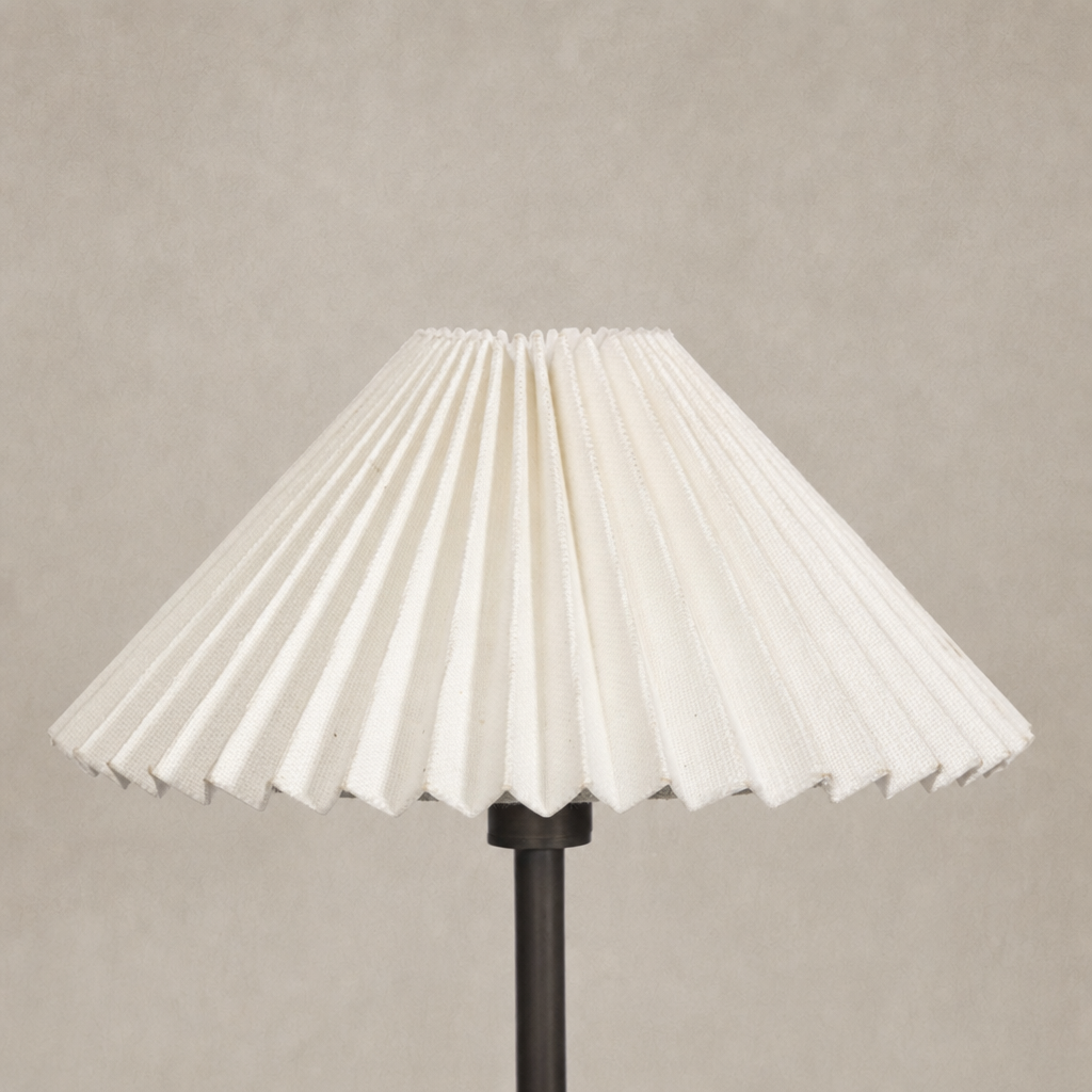 Light oil rubbed bronze chandelier with pleated white fabric shade.