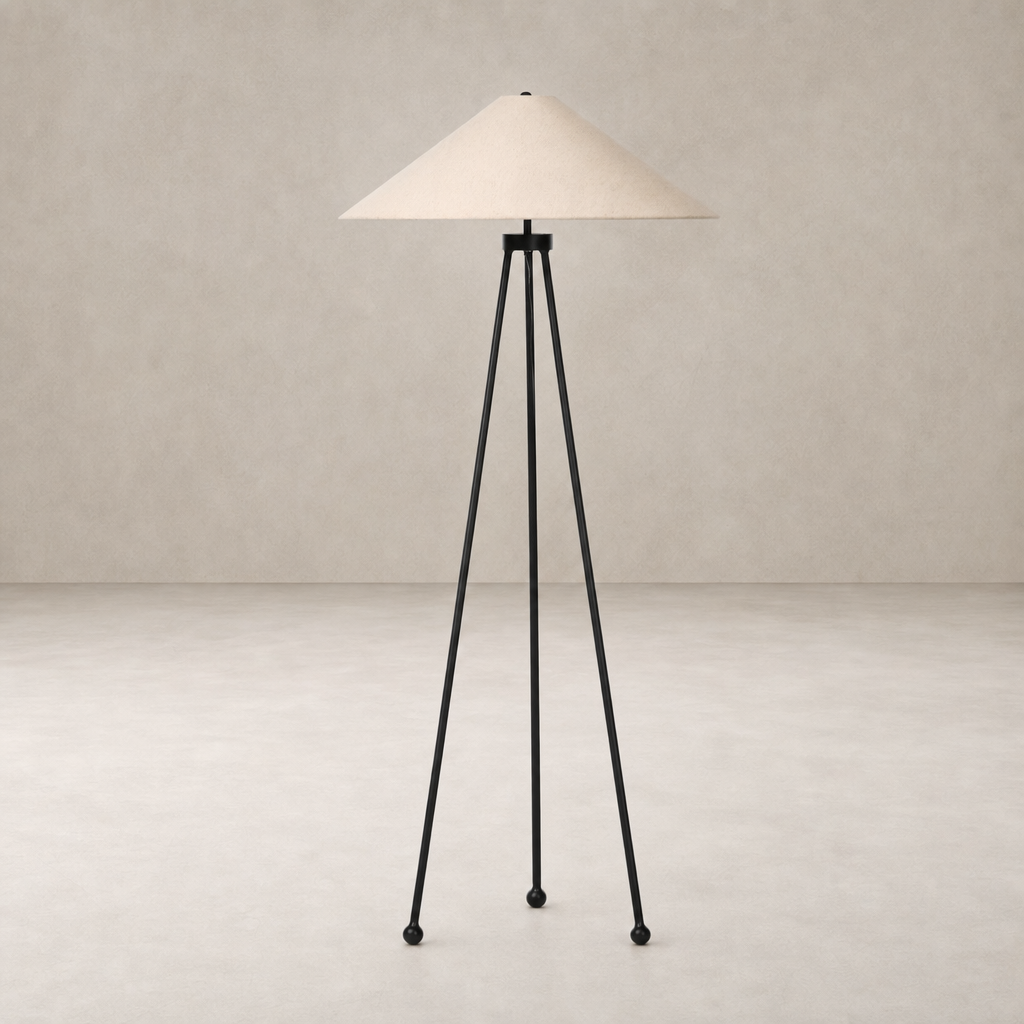 Matte black floor lamp with a conical shade and tripod legs for modern decor.