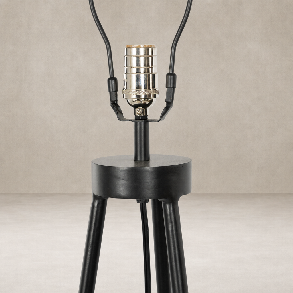Matte black floor lamp base with a cylindrical shape and tripod legs.