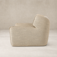 Allora Swivel Chair in Saxon Sand features a soft, textured fabric with a modern shape.