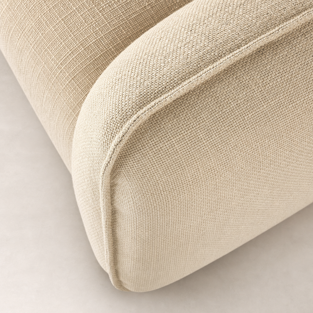 Close-up of Allora Swivel Chair in Saxon Sand showcasing textured fabric and rounded edges.