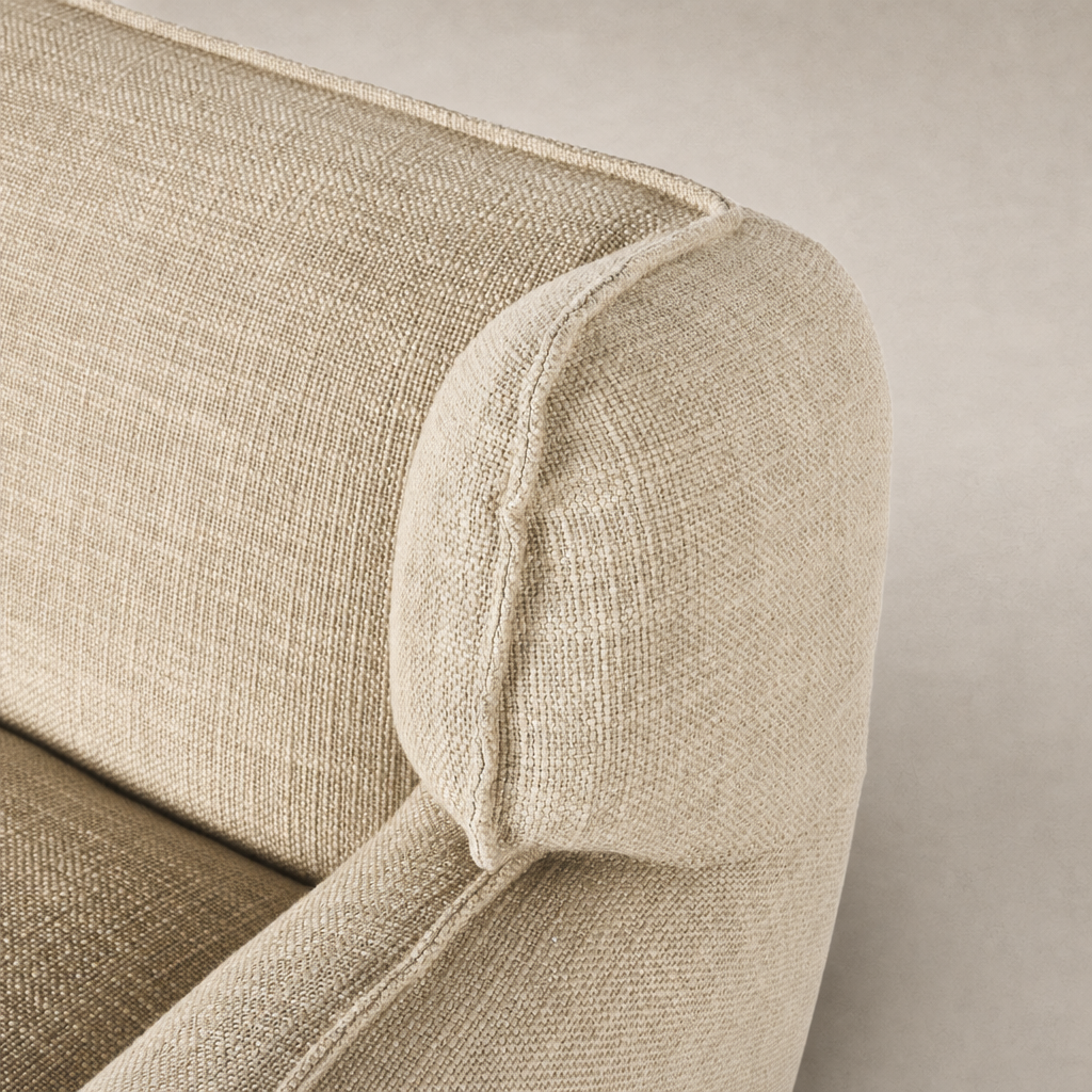 Close-up of Allora Swivel Chair in Saxon Sand, featuring textured fabric and rounded armrest.