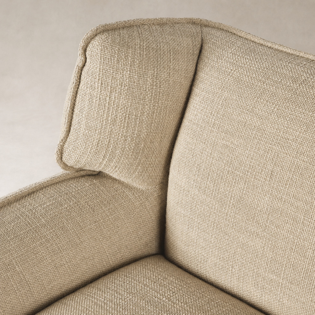 Close-up of Allora Swivel Chair in Saxon Sand, showcasing textured fabric and rounded armrests.