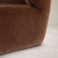 Allora Swivel Chair in Surrey Ochre showcasing soft, plush fabric with rounded edges.