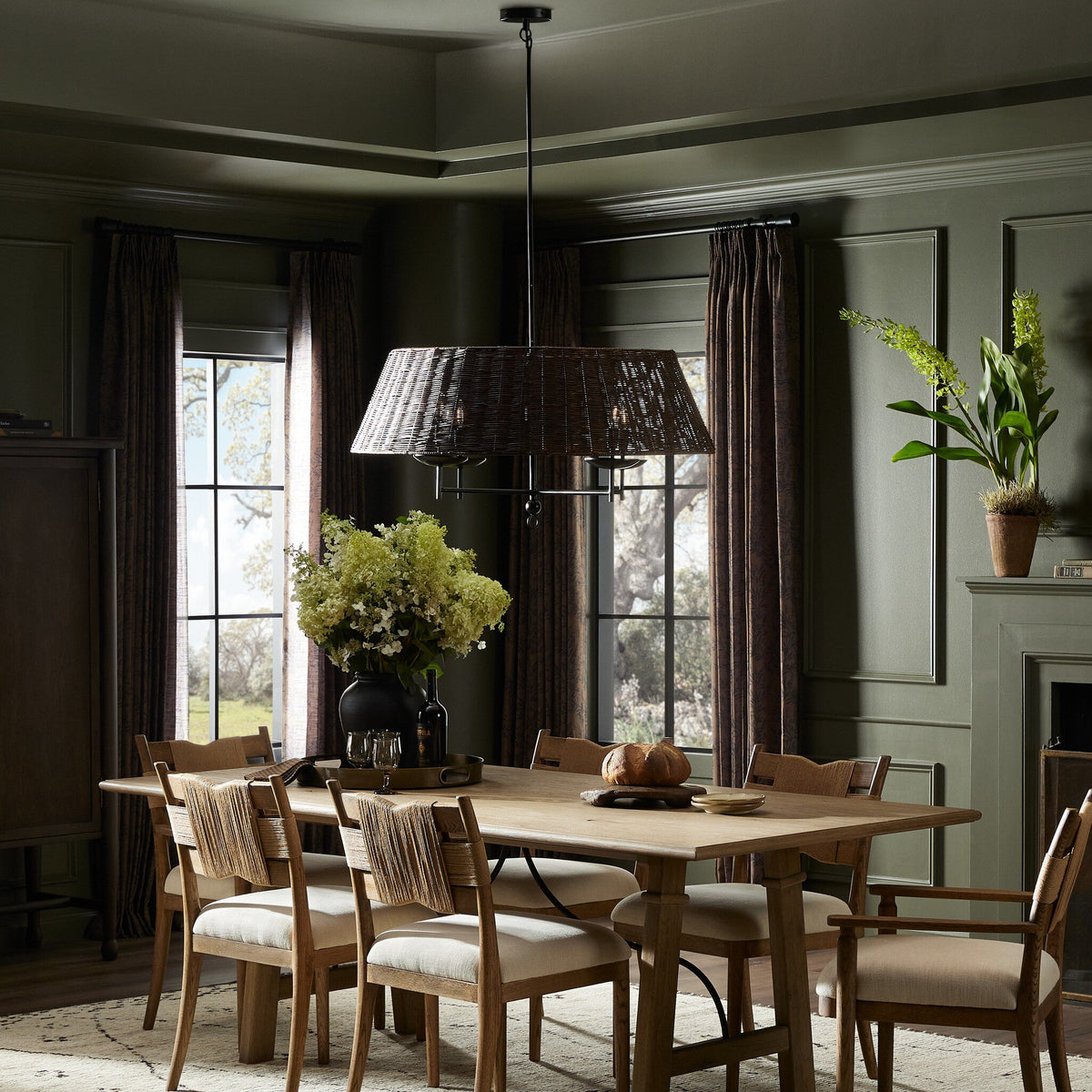 Harrow Chandelier in jet black adding elegance to a cozy dining room setting.