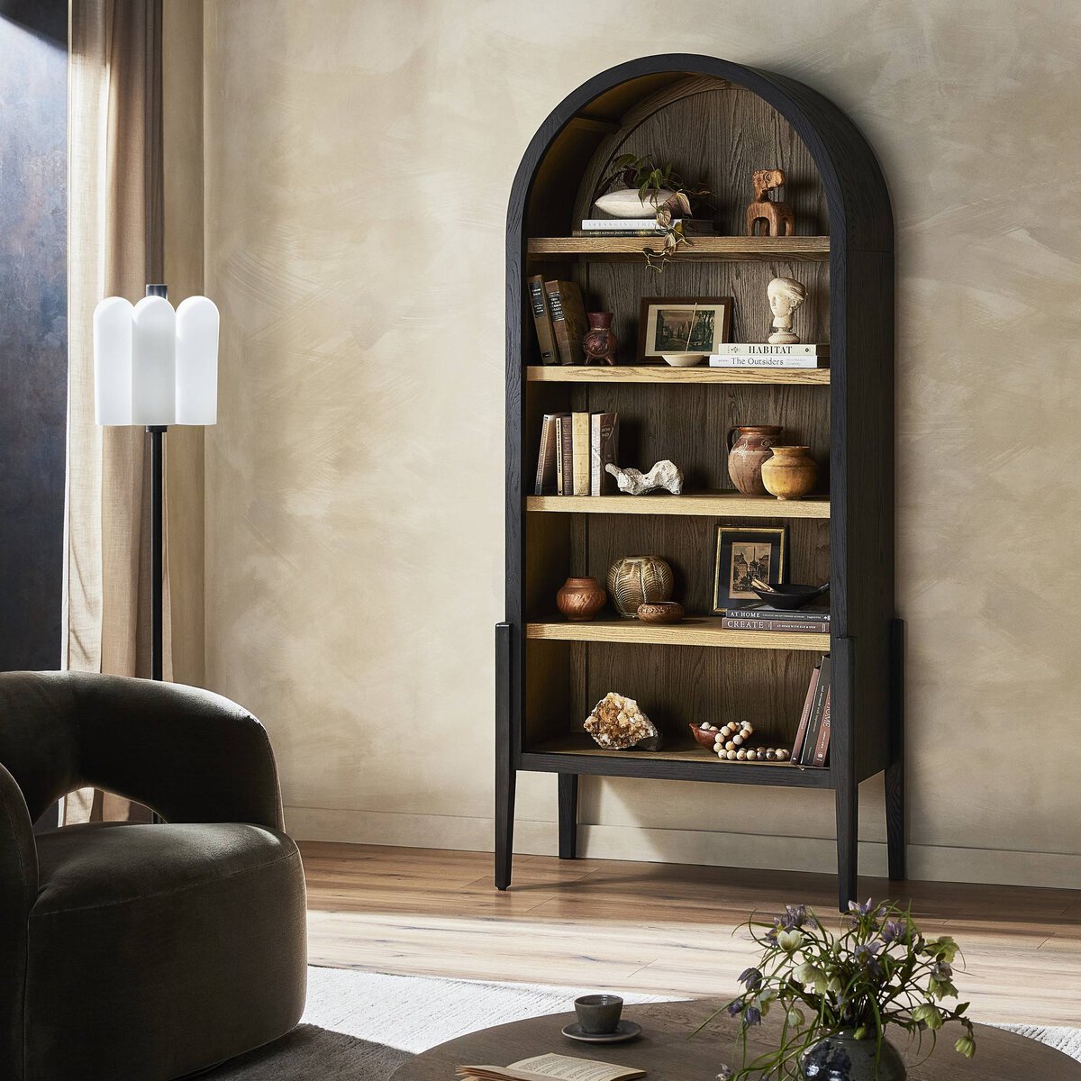 Three-quarter view of the Ember Bookcase featuring a sleek black frame and natural wood shelves.
