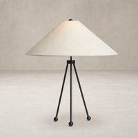 Matte black tripod table lamp with a conical cream shade.
