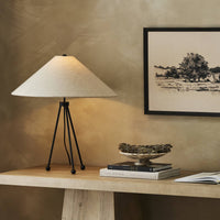 Matte black table lamp with a conical shade and tripod base.