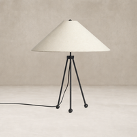 Matte black table lamp with a conical shade and tripod base design.
