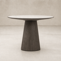 Romina Round Dining Table with a white marble top and unique dark wood base.