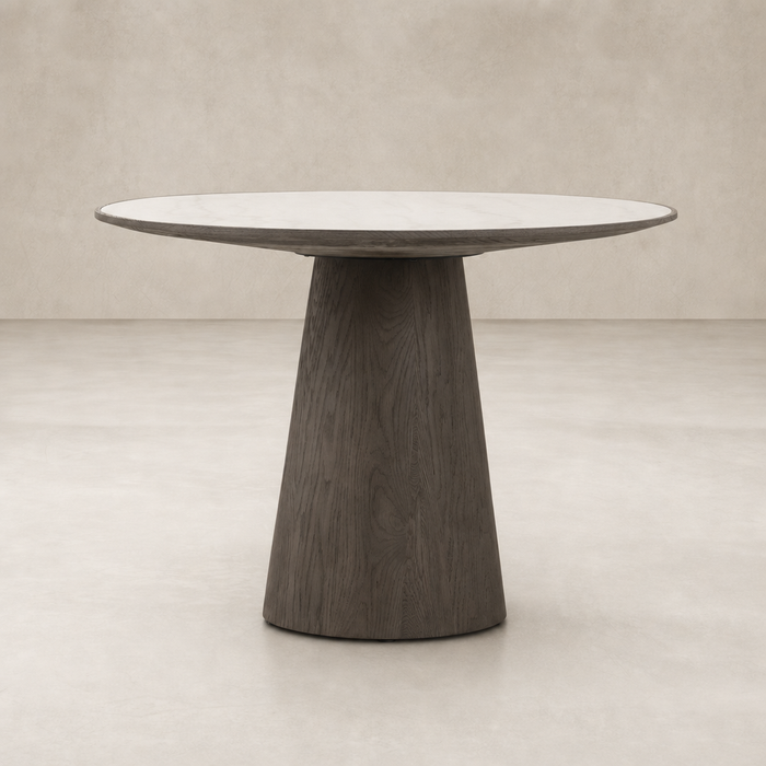 Romina Round Dining Table with a white marble top and unique dark wood base.