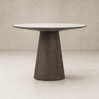 Romina Round Dining Table features a sleek white marble top and a modern dark wood base.