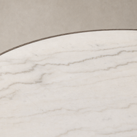 Close-up of the Romina Round Dining Table featuring a sleek white marble surface.