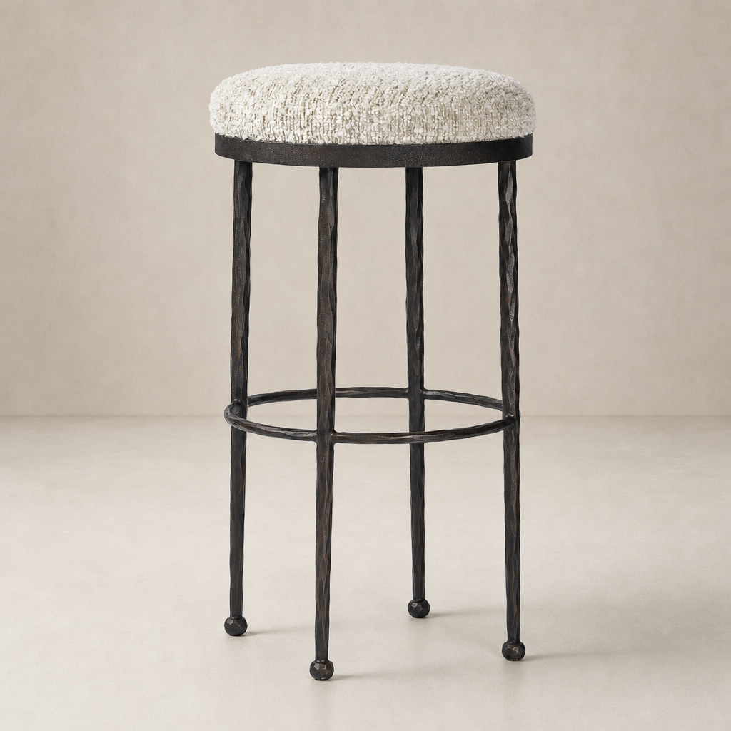 Jasper Bar + Counter Stool in Ivan Stone with textured seat and sleek black metal legs.