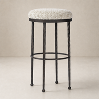 Jasper Bar + Counter Stool in Ivan Stone with textured seat and sleek black metal legs.