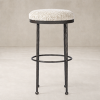 Jasper Bar + Counter Stool in Ivan Stone features a plush, round upholstered seat and a sturdy metal frame.