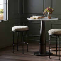 Jasper Bar + Counter Stool in Ivan Stone features a textured fabric seat and sturdy metal legs.