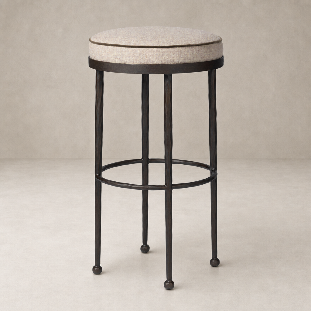 Jasper Bar + Counter Stool featuring Alcala Taupe upholstered seat and sturdy black metal legs.