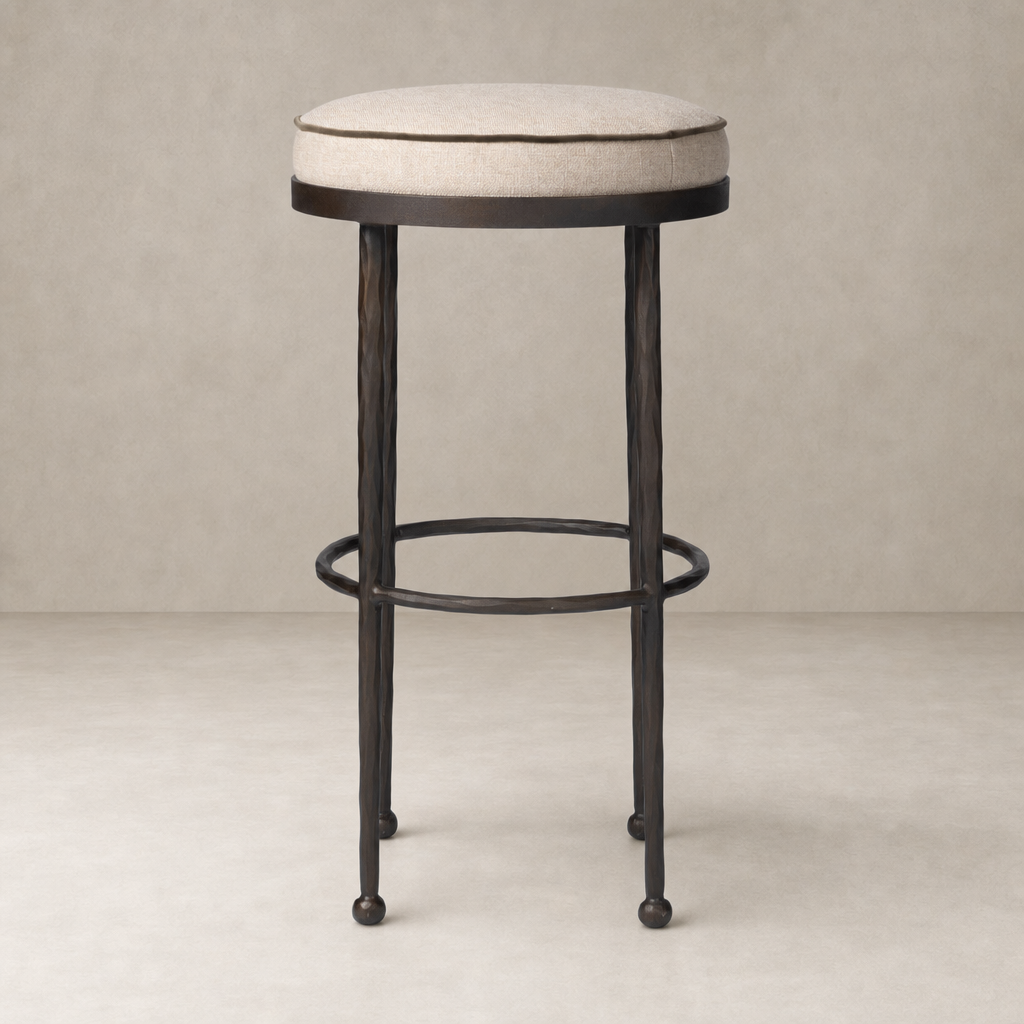 Jasper Bar + Counter Stool in Alcala Taupe with a round padded seat and metal legs.