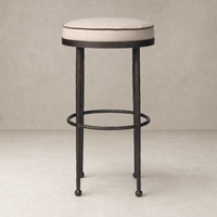 Jasper Bar + Counter Stool in Alcala Taupe with a round padded seat and metal legs.