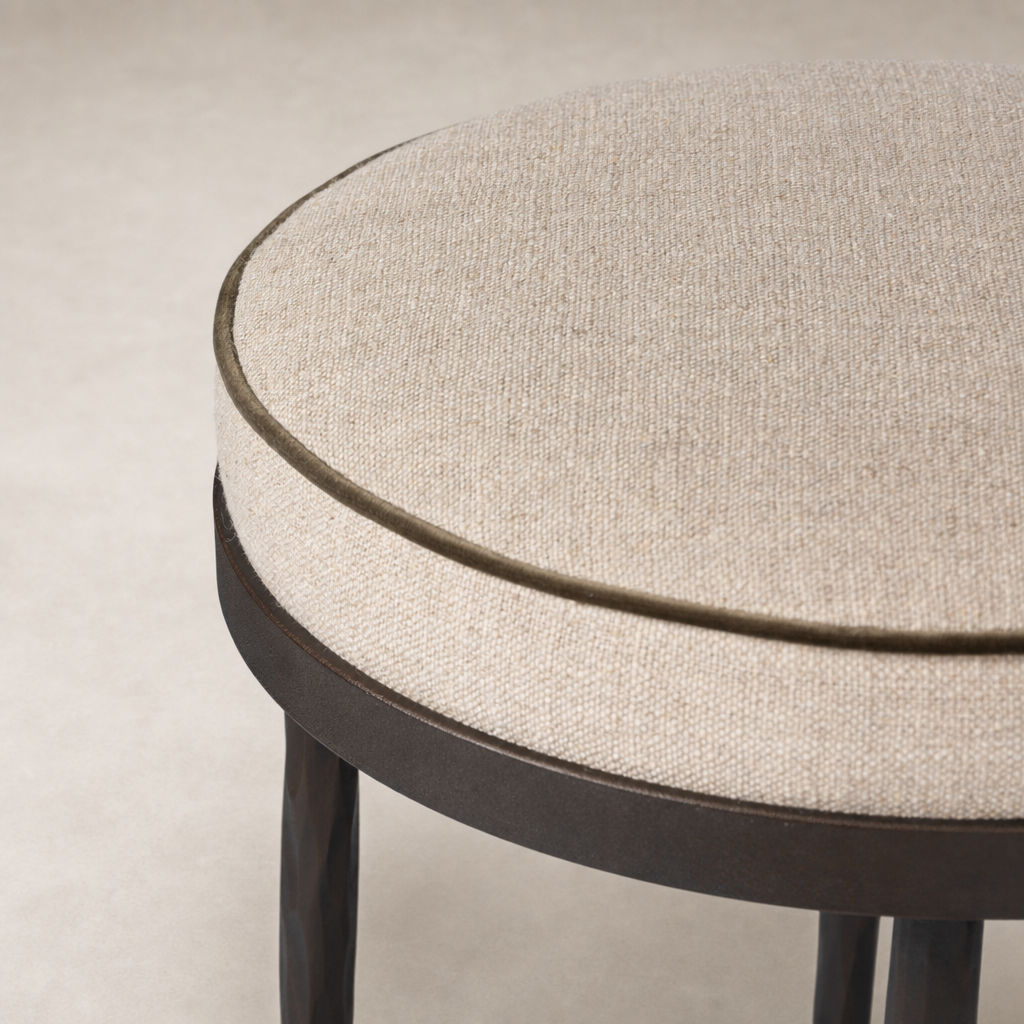 Jasper Bar + Counter Stool in Alcala Taupe features a round upholstered seat with a textured finish.