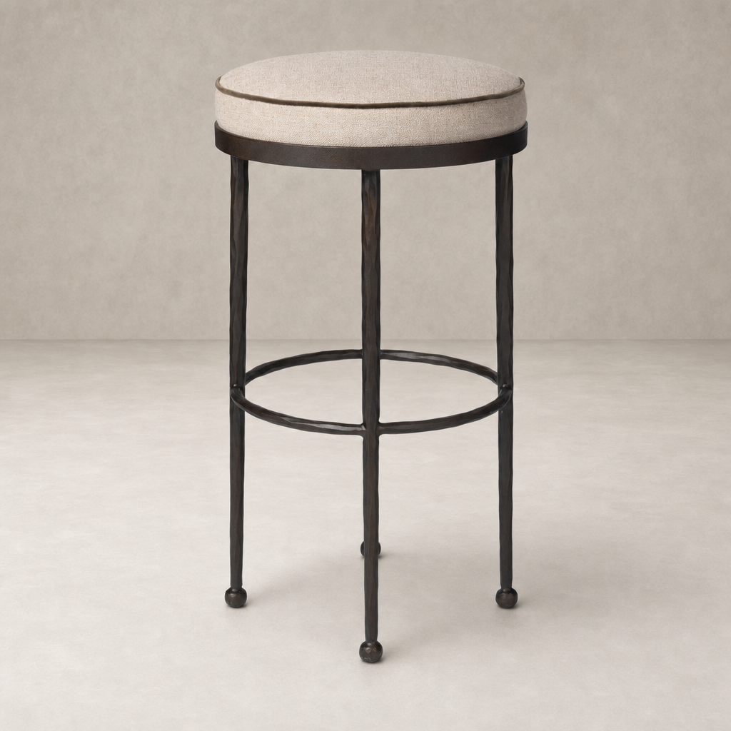 Jasper Bar + Counter Stool in Alcala Taupe with a round upholstered seat and sleek metal legs.