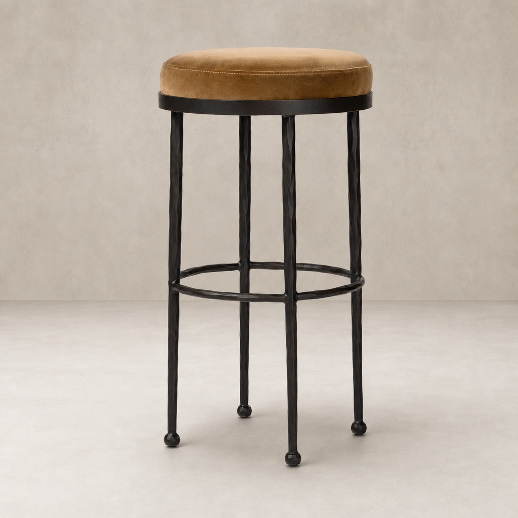 Jasper Bar + Counter Stool in Surrey Ochre with a round velvet seat and sleek metal frame.