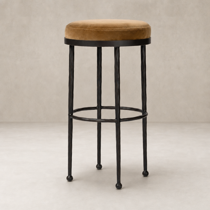 Jasper Bar + Counter Stool in Surrey Ochre with a round velvet seat and sleek metal frame.