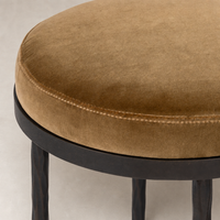 Surrey Ochre Jasper Bar + Counter Stool features a plush, round seat with textured fabric.