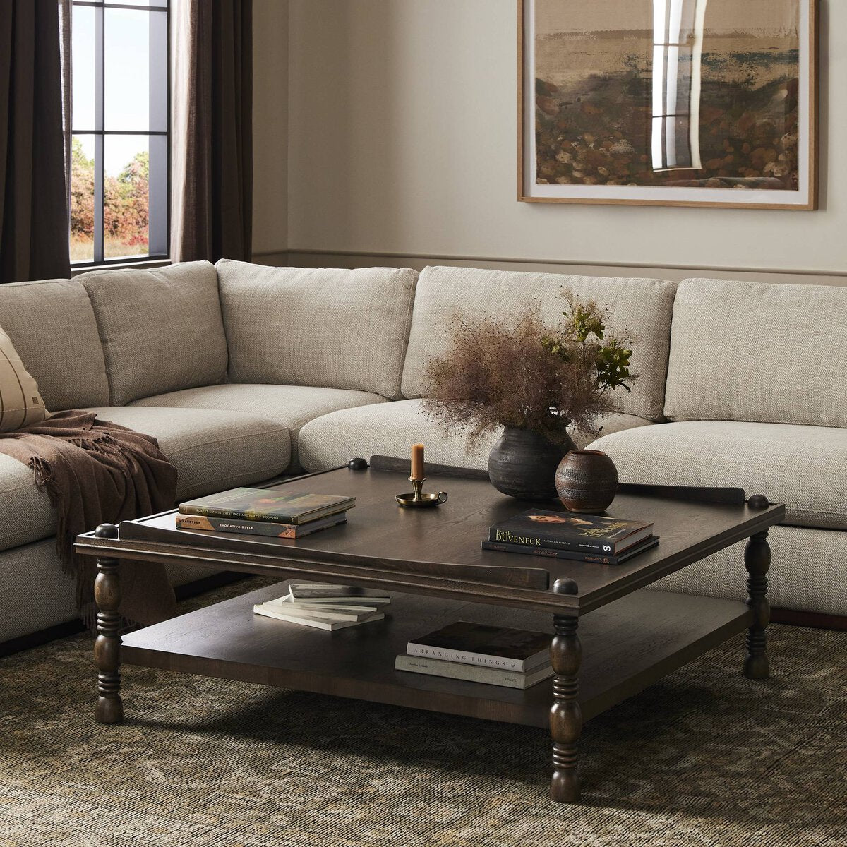 Close-up of the Zephyr Coffee Table showcasing its rich wood finish and decorative turned legs.