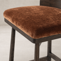 Quito Swivel Bar + Counter Stool in Altair Sienna with plush velvet seat and dark wooden legs.