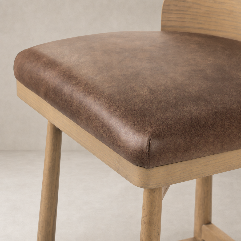 Quito Swivel Bar + Counter Stool in Palermo Cigar with a soft textured seat and natural wood legs.