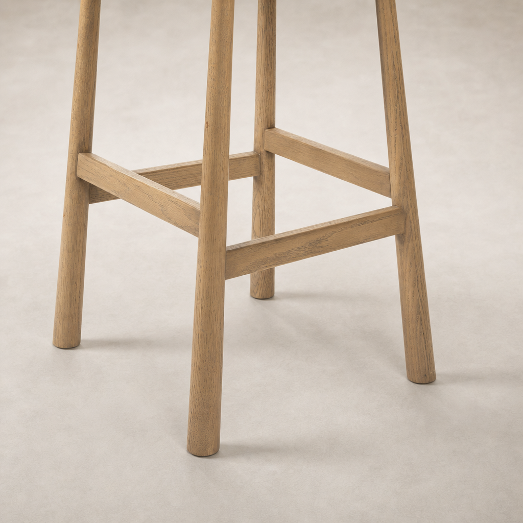 Close-up of Quito Swivel Bar + Counter Stool in Palermo Cigar finish, showcasing its sturdy wooden legs.
