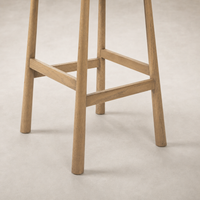 Close-up of Quito Swivel Bar + Counter Stool in Palermo Cigar finish, showcasing its sturdy wooden legs.