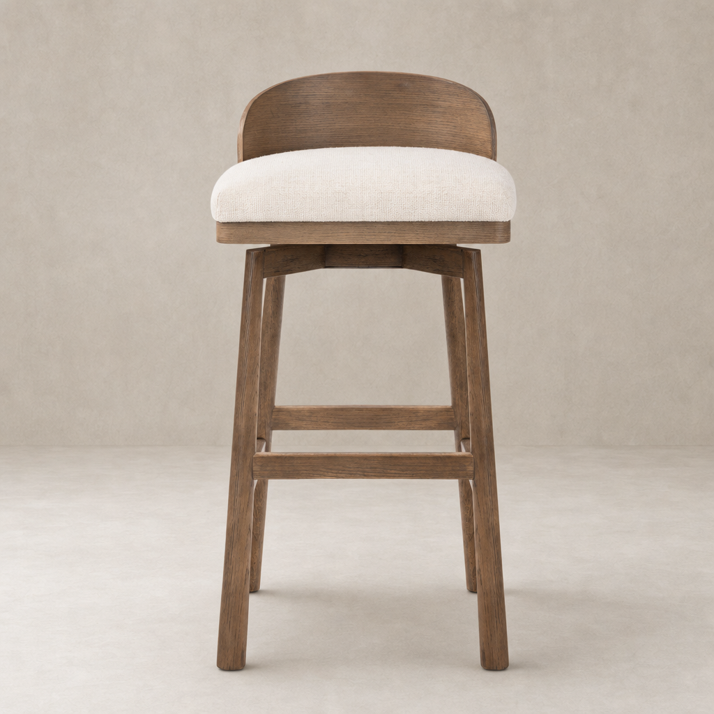 Quito Swivel Bar + Counter Stool in Thames Cream with a curved back and sturdy wood legs.