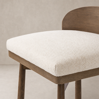 Quito Swivel Bar + Counter Stool in Thames Cream featuring a textured seat and wood finish.