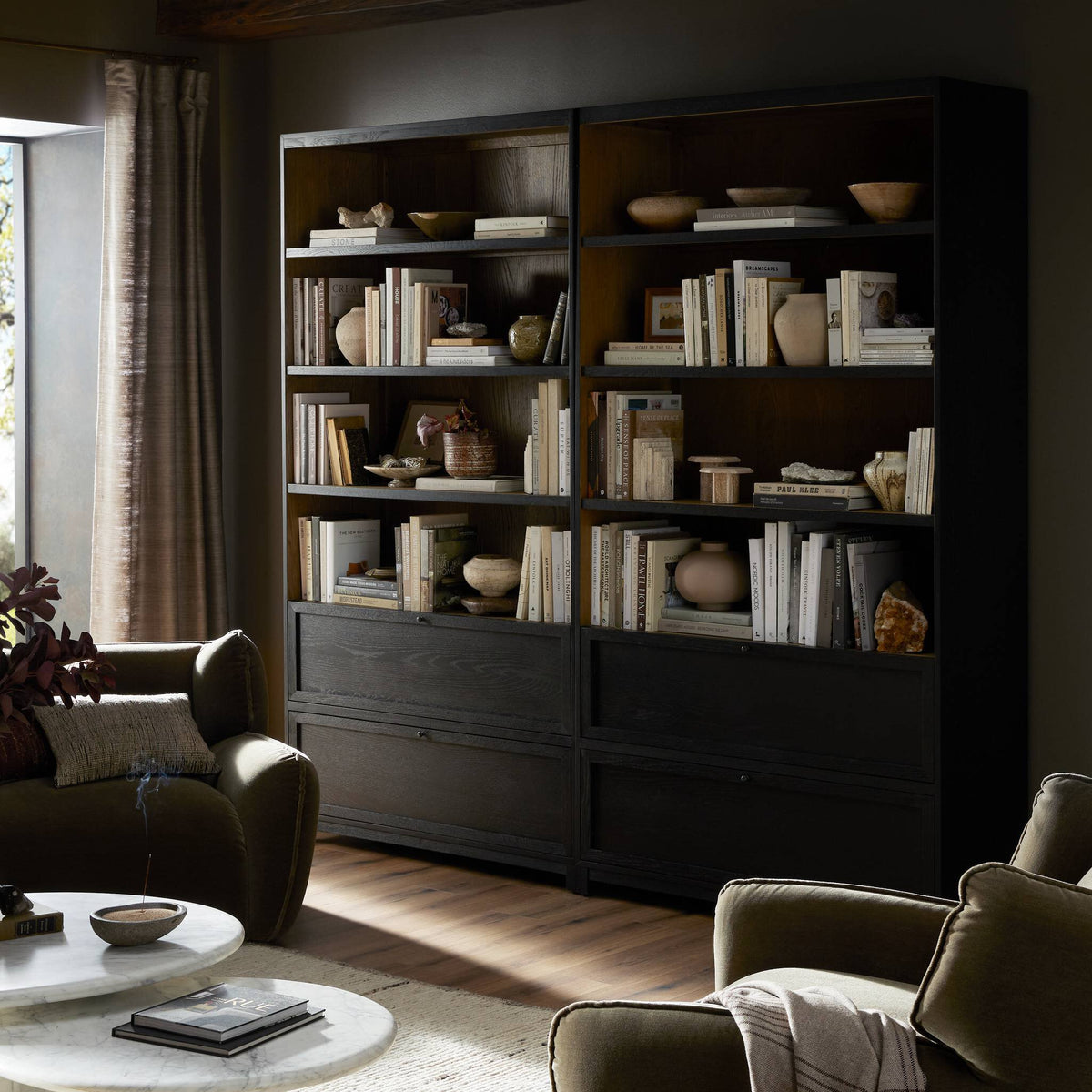 Osaka Bookcase in drifted matte black with open shelves showcasing decorative items.