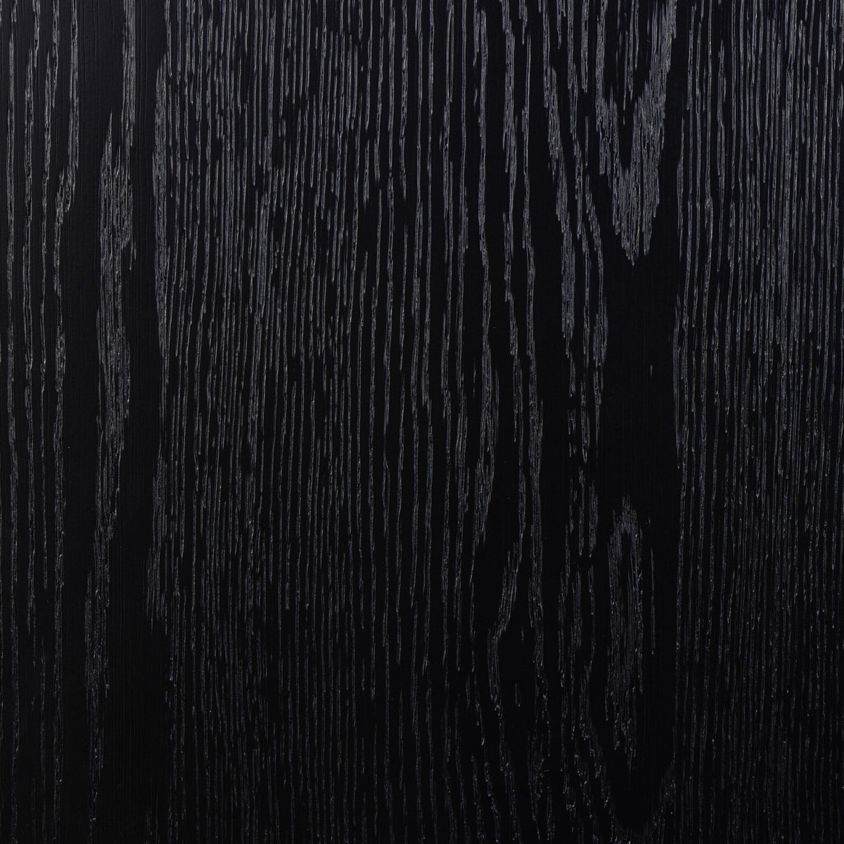 Close-up of Osaka Bookcase's drifted matte black textured wood finish.
