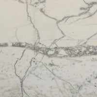 Close-up of veined white marble finish on Sloane Outdoor Dining Table.