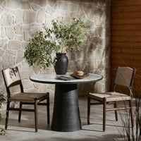 Sloane Outdoor Dining Table with veined white marble top and modern black pedestal base.