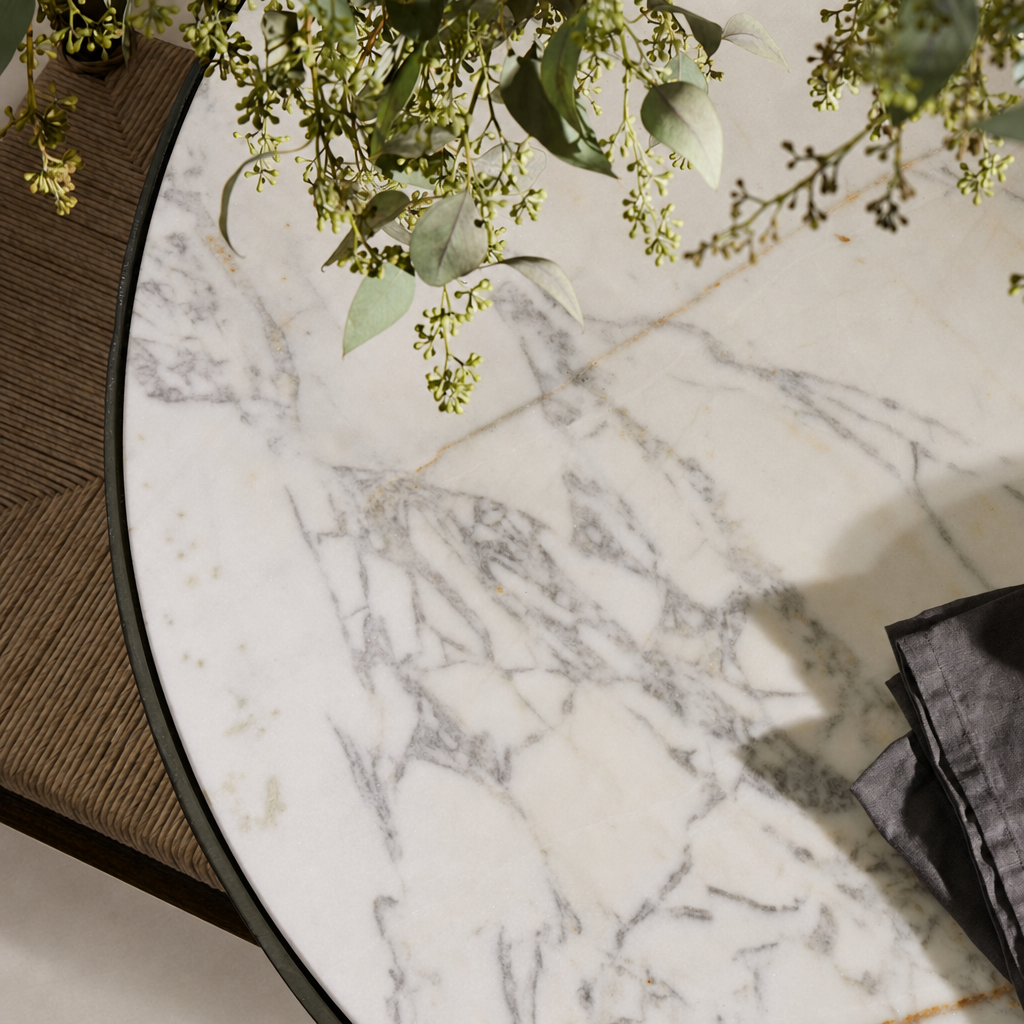 Sloane Outdoor Dining Table featuring a stunning veined white marble top.