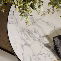 Sloane Outdoor Dining Table featuring a stunning veined white marble top.
