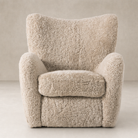 Beige shearling Elodie Chair featuring plush cushioning and curved arms for comfort.
