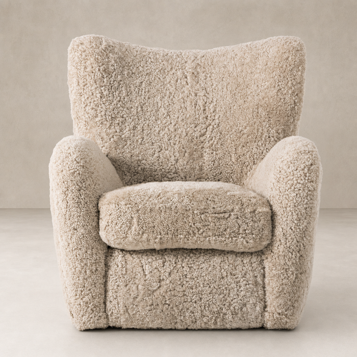 Beige shearling Elodie Chair featuring plush cushioning and curved arms for comfort.