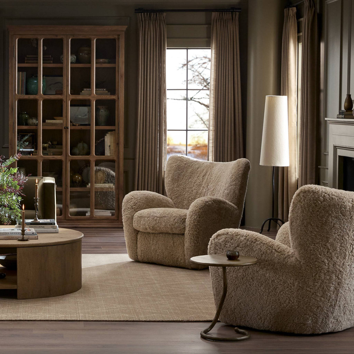 Elodie Chair in beige shearling with cozy, rounded shape in a stylish living room setting.