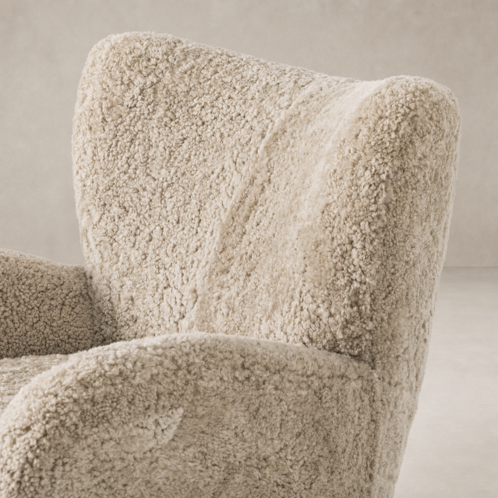 Beige shearling Elodie Chair featuring a plush, textured upholstery and curved backrest.